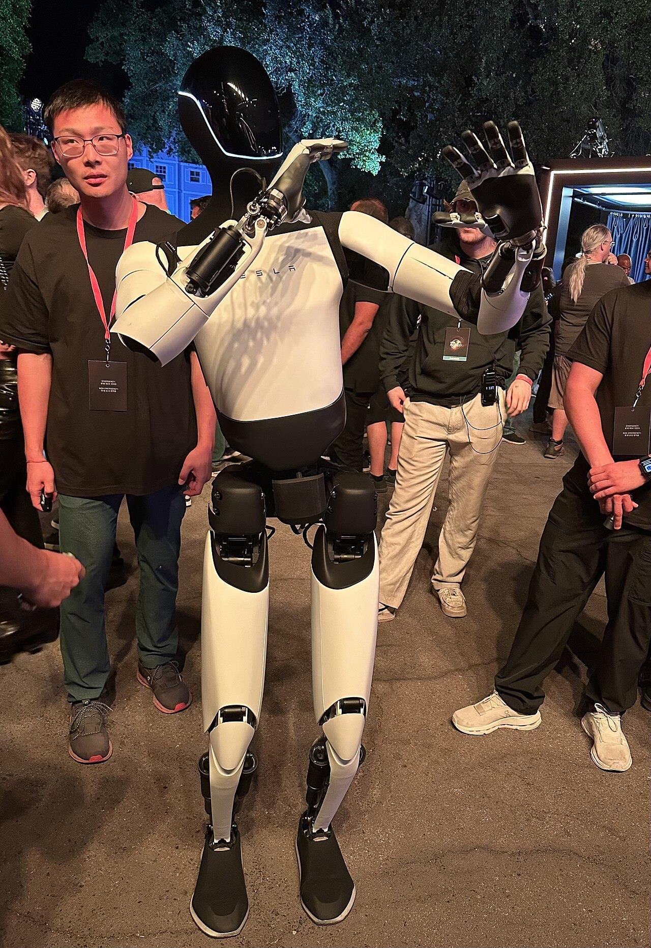 A humanoid robot surrounded by engineers