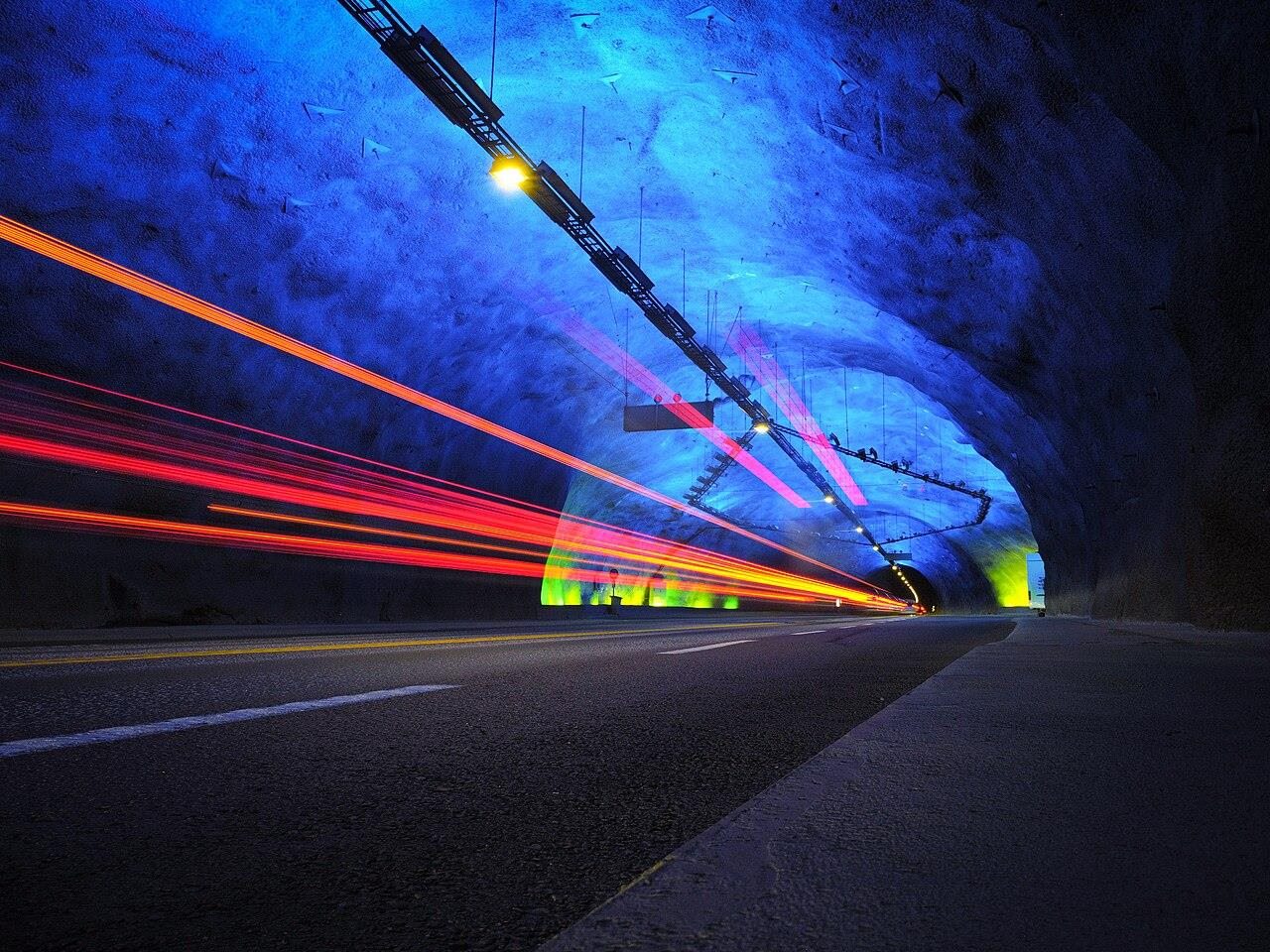 Light trails through a road tunnel at night